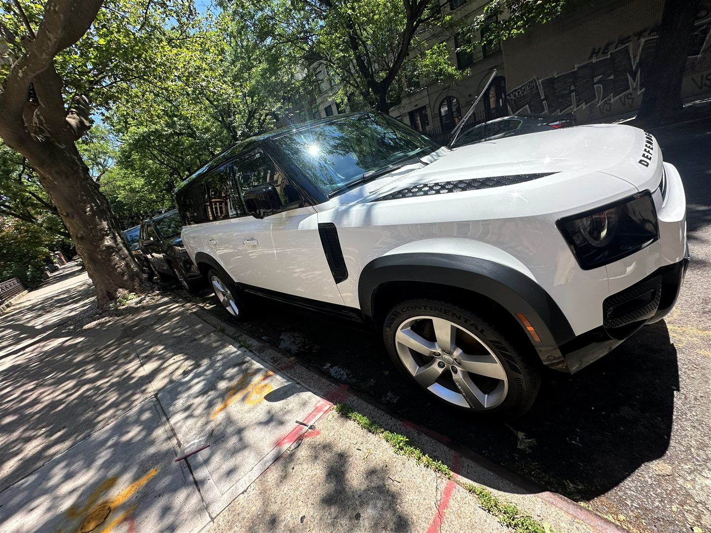 Land Rover Defender exterior after mobile detail — glossy white paint and clean wheels