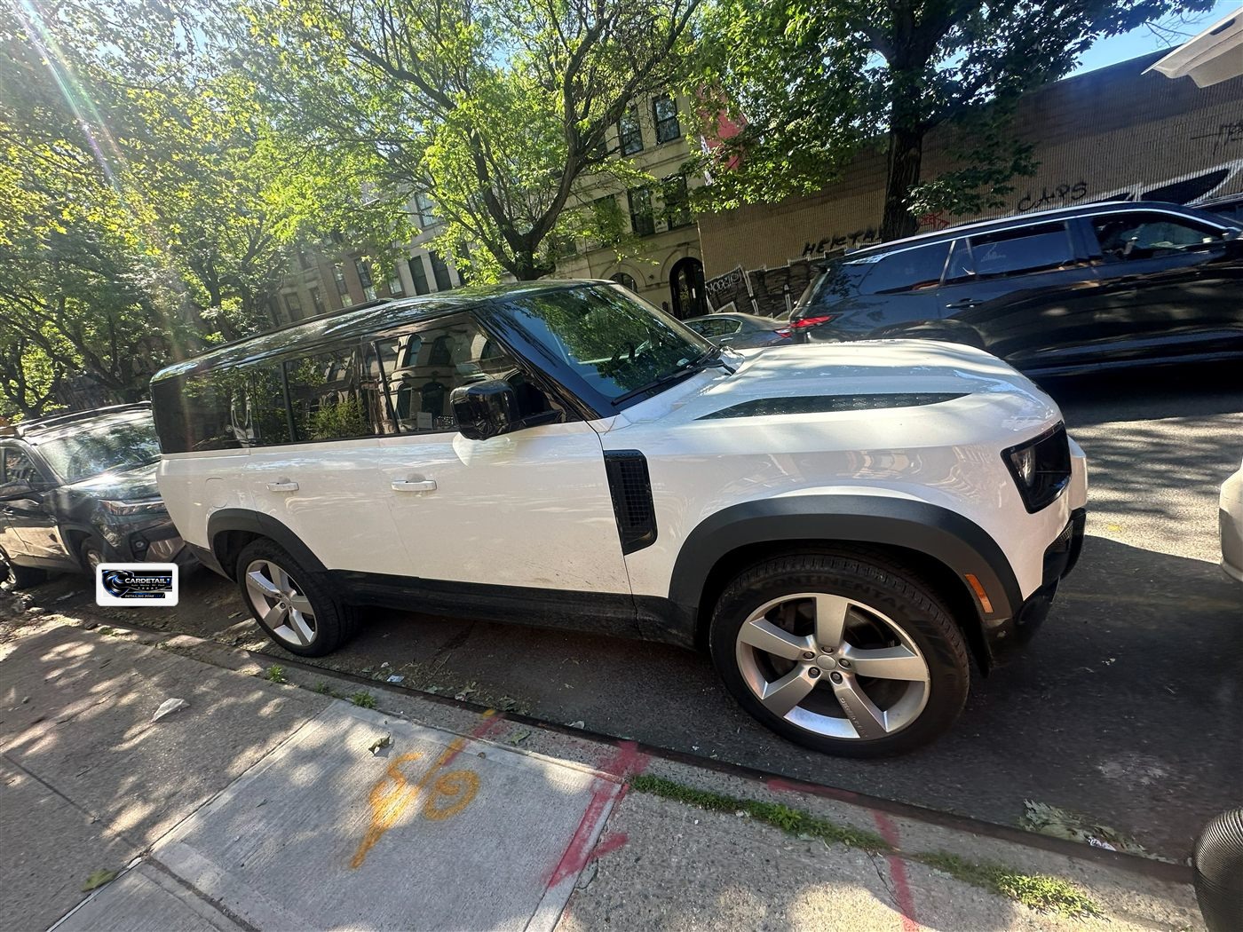 Land Rover Defender exterior before mobile detail — road film and dusty wheels