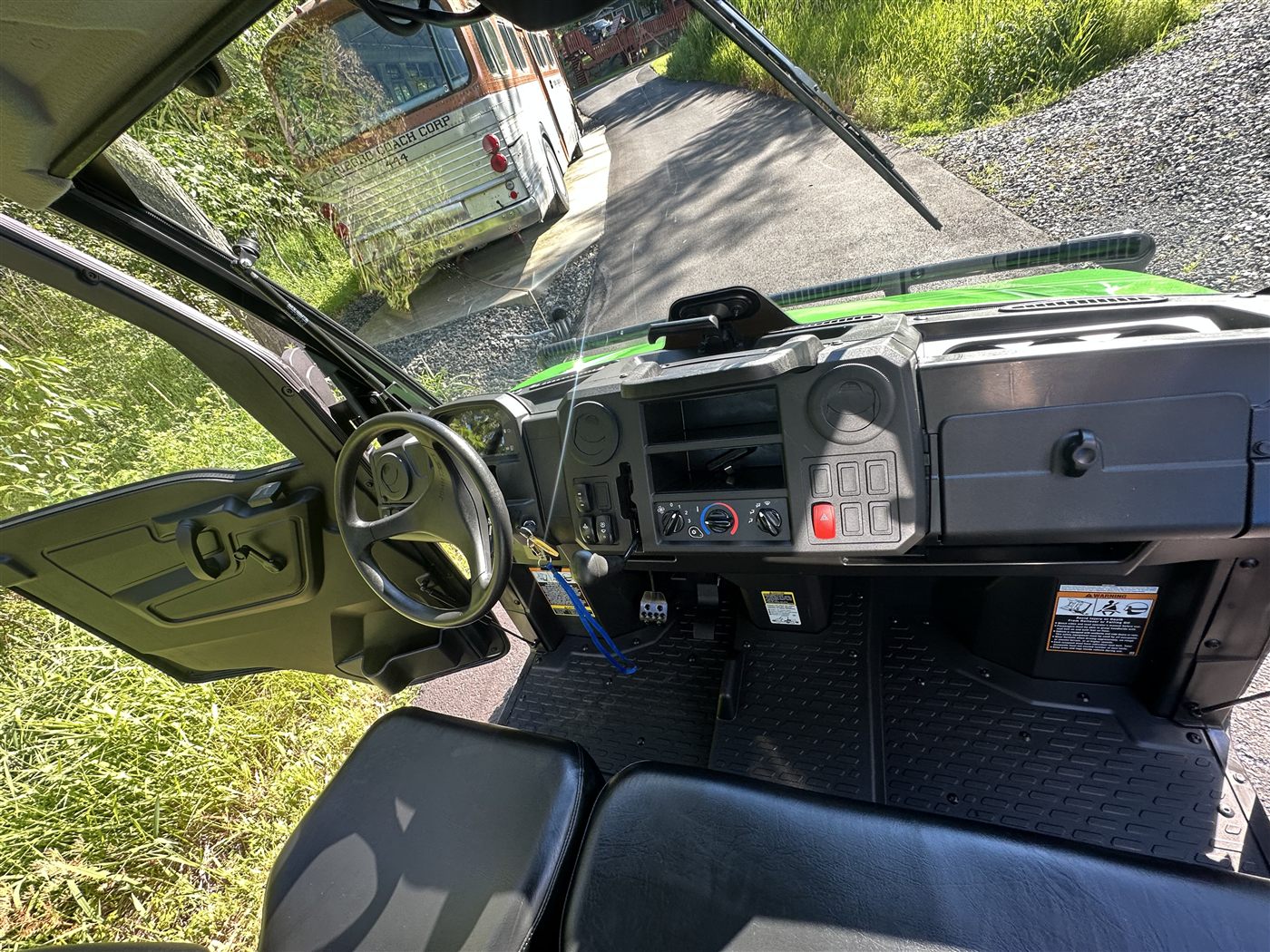 John Deere Gator interior after deep cleaning — spotless dash, floor mats, and seats