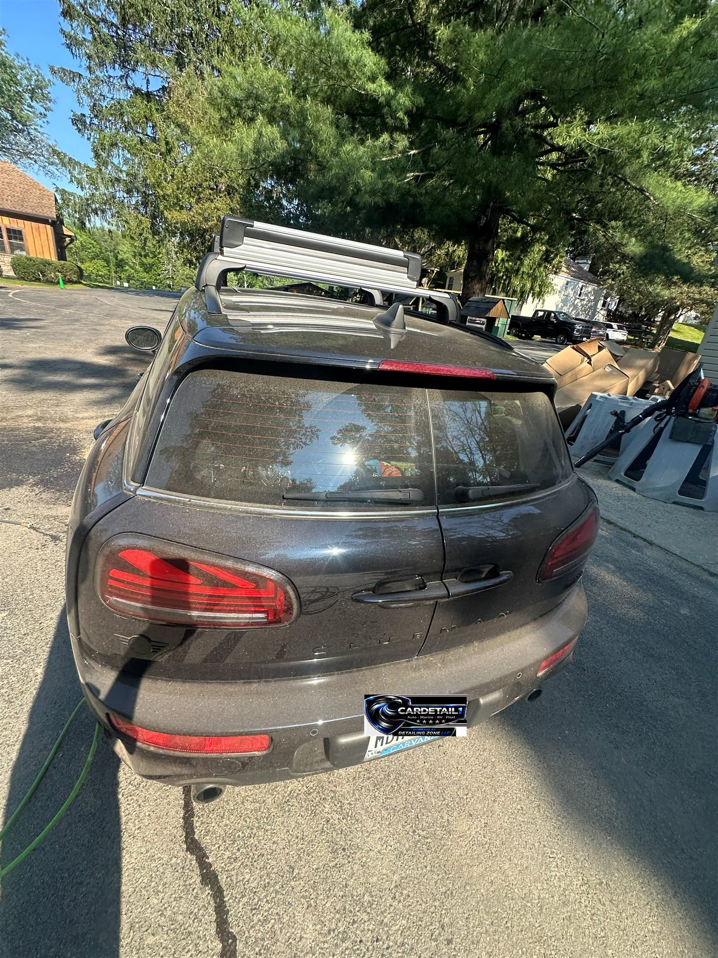 Mini Cooper Clubman rear before exterior detail — thick dust on barn doors and bumper