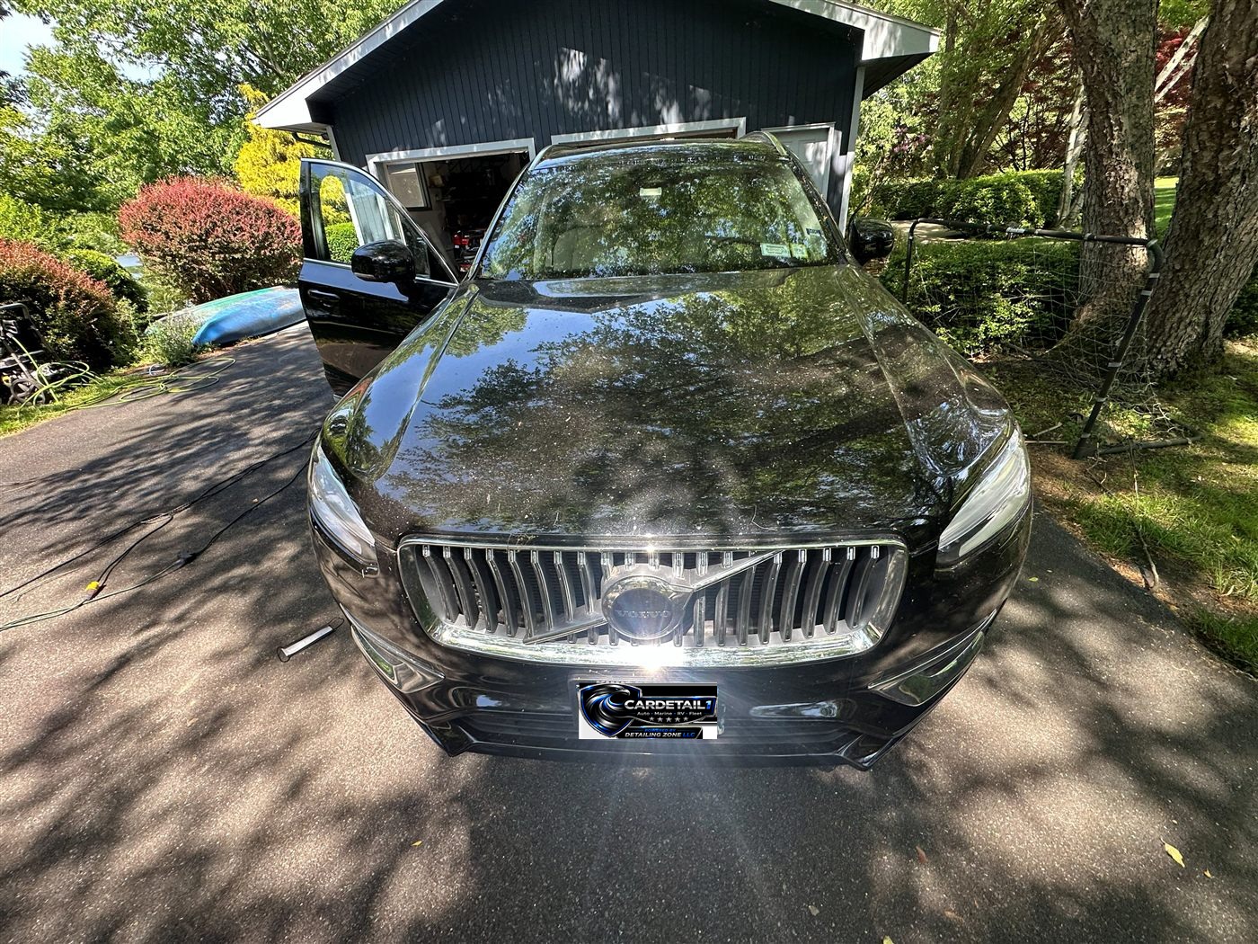 Volvo XC90 exterior before mobile detail — pollen and dust on black hood