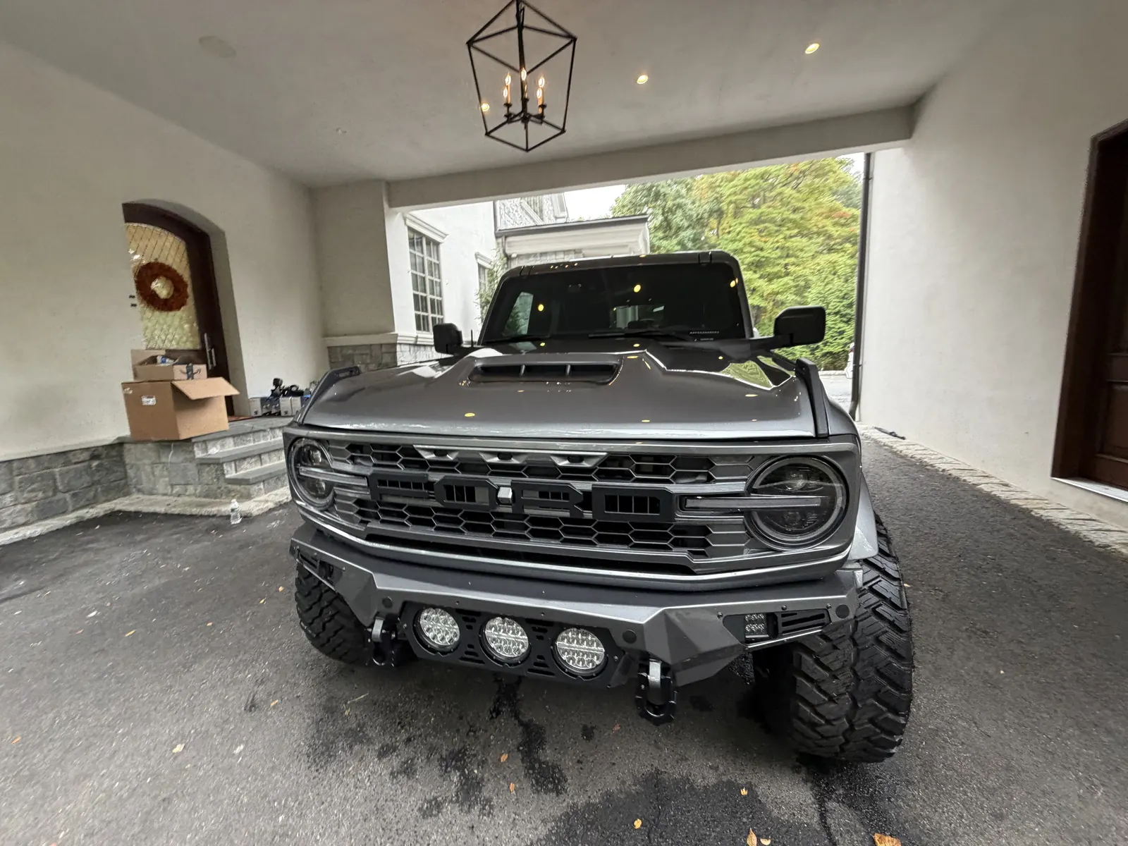 Gray Ford Bronco front view under a covered entry