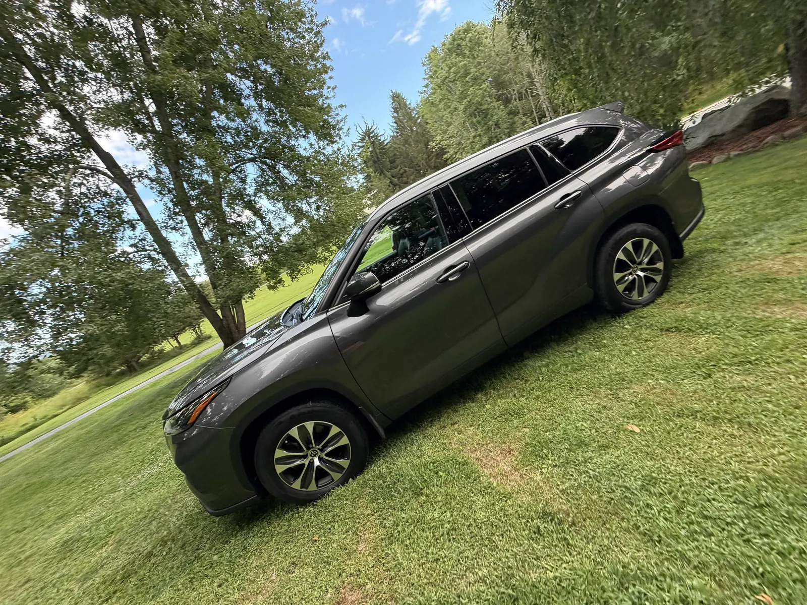 Gray Toyota Highlander side view on grass