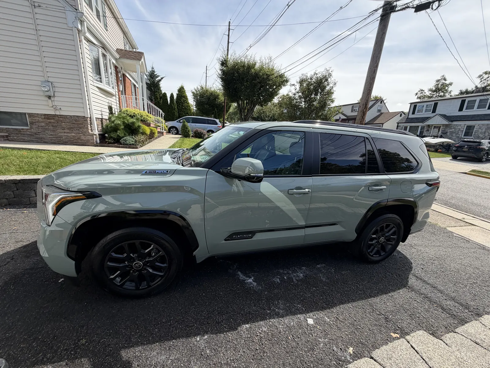 Sage Toyota Sequoia side view parked on a residential street