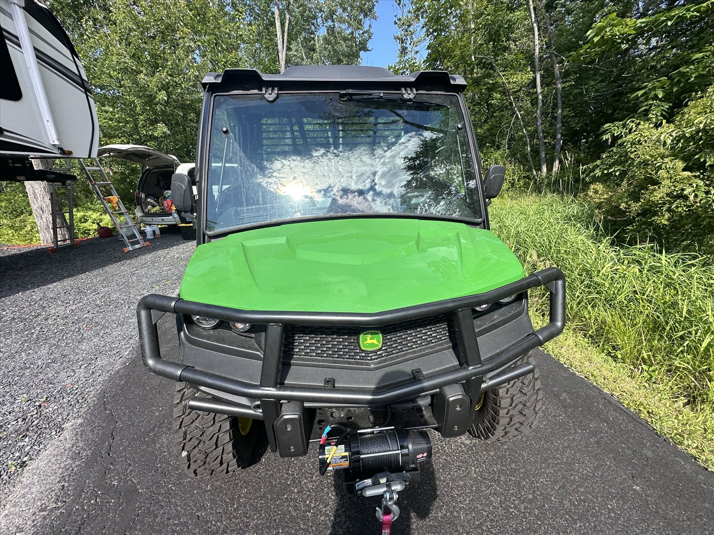 John Deere Gator XUV835M side profile after full exterior detail — polished green panels and dressed off-road tires